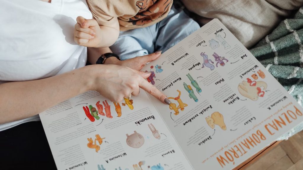 A comforting moment of a mother reading a colorful picture book with her child.